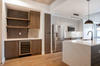 A modern kitchen with wooden cabinets and stainless steel appliances.